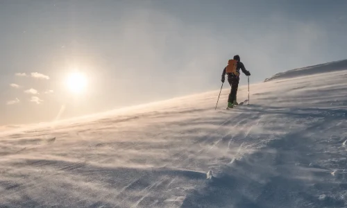 skier-with-backpacker-hiking-on-snow-hill-at-sunse-2025-03-25-17-22-30-utc